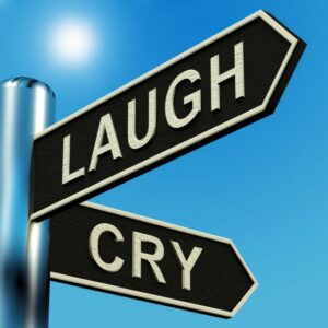 Signpost reading "Laugh" and "Cry"